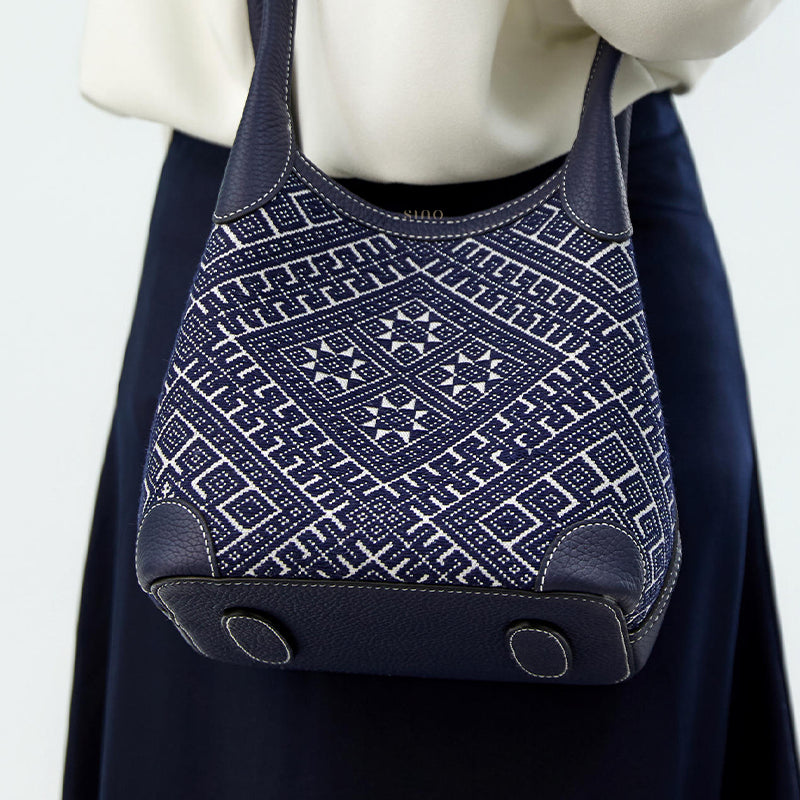 Zhuang brocade basket tote bag worn on model back view, showing bag shape, strap length, and natural drape against outfit.