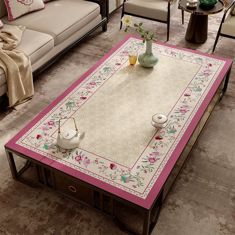 Coral pink leather coffee table mat with Chinoiserie floral border.