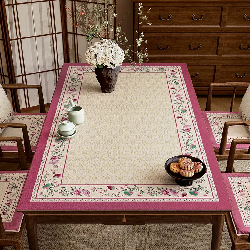Coral pink leather dining table mat with Chinoiserie floral border.