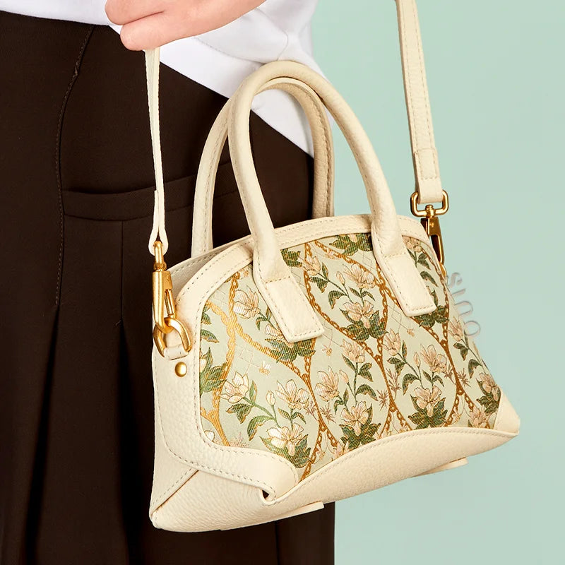 Model wearing the Dayun Brocade Verdant Floral top handle bag with its detachable shoulder strap.