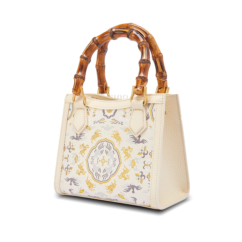 Front view of Song Brocade bamboo handle handbag with Deer and Crane in Spring motif symbolizing harmony, prosperity, and seasonal renewal.
