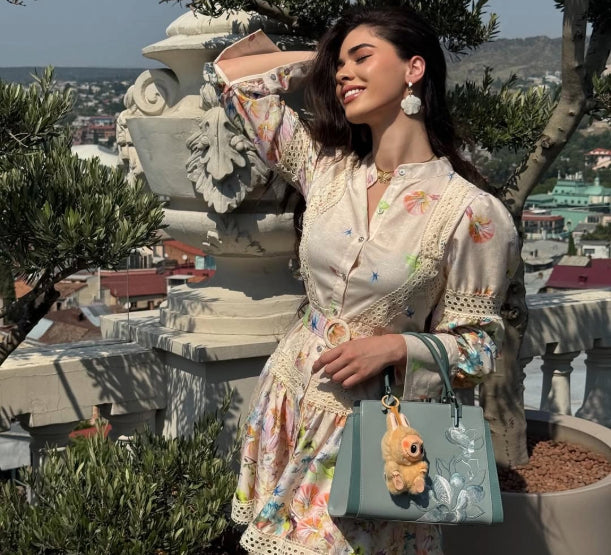 @elenne.kach wearing our Embroidery Magnolia Crossbody Tote Bag outdoors.