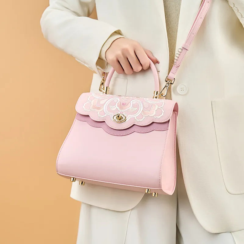 Model crossbody carrying the pink embroidery leather ladies cute handbag with treasure floral design.