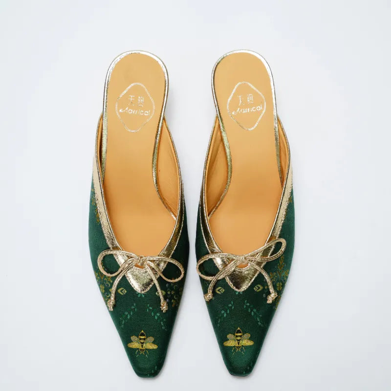 Top view of emerald Shu Brocade mule heels featuring gold accents and traditional Chinese textile patterns.