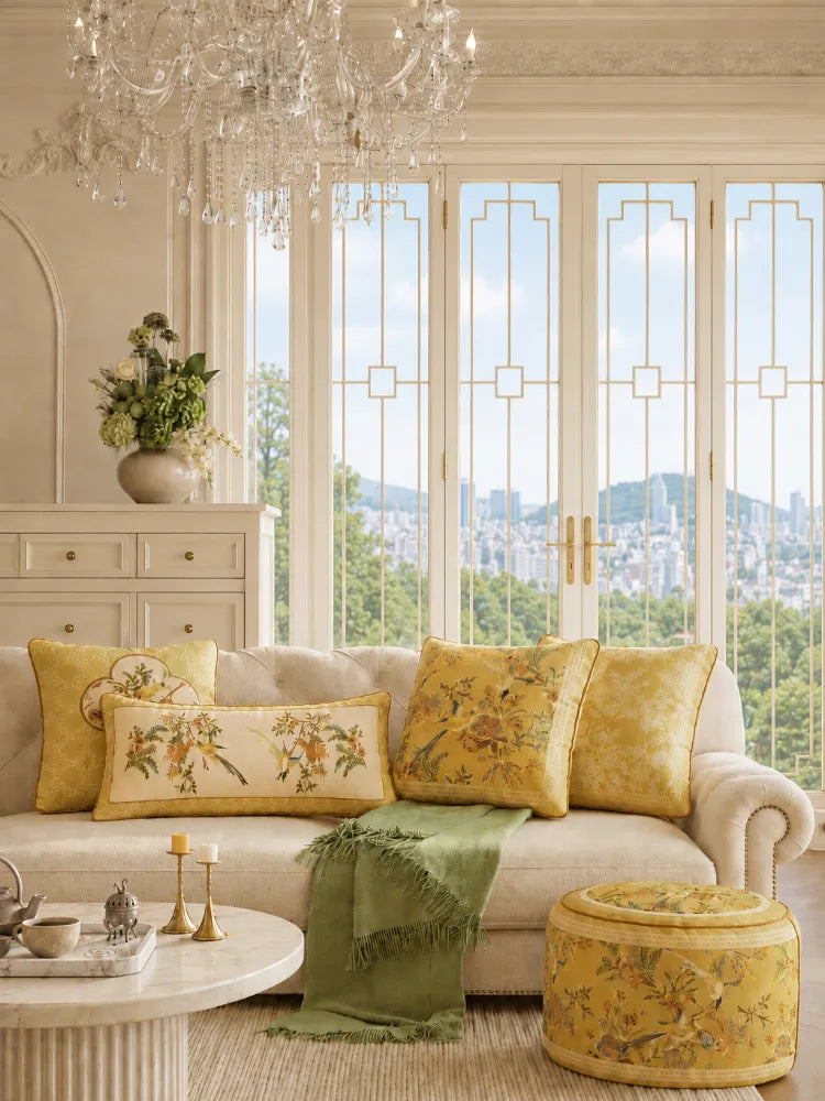 Warm fall and winter Chinoiserie home decor with yellow floral cushions, green accents, and coordinated Chinese-inspired patterns in an elegant living room.