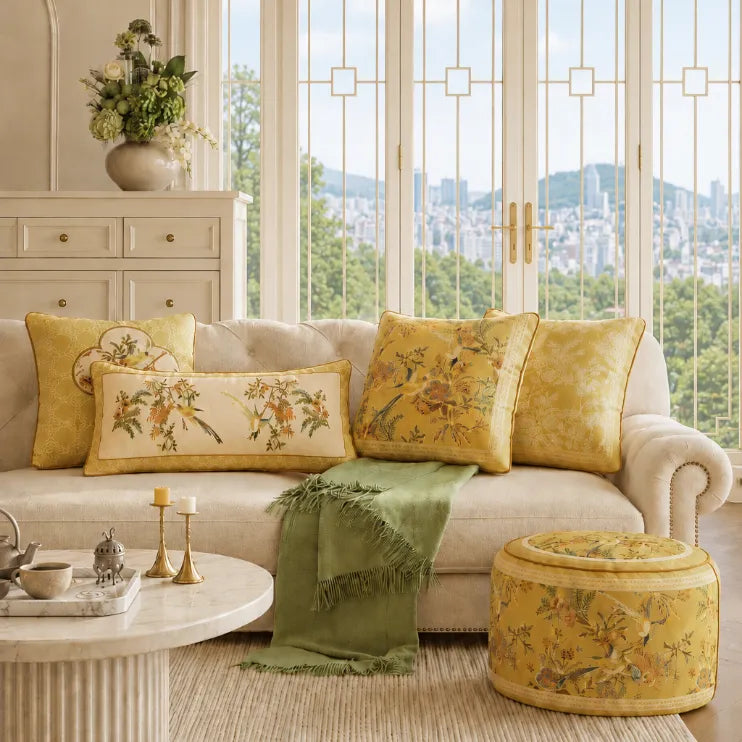 Warm fall and winter Chinoiserie home decor with yellow floral cushions, green accents, and coordinated Chinese-inspired patterns in an elegant living room.