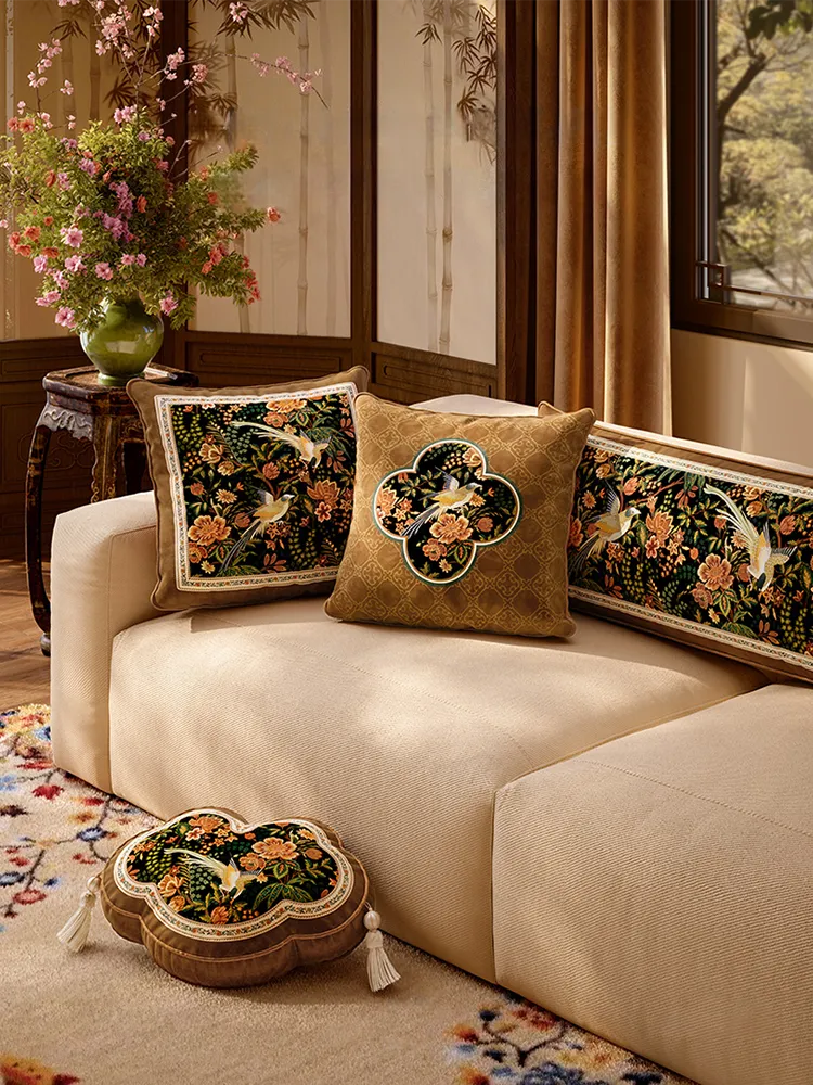Beige sofa with Chinese floral-bird pillows for fall-winter home decor.