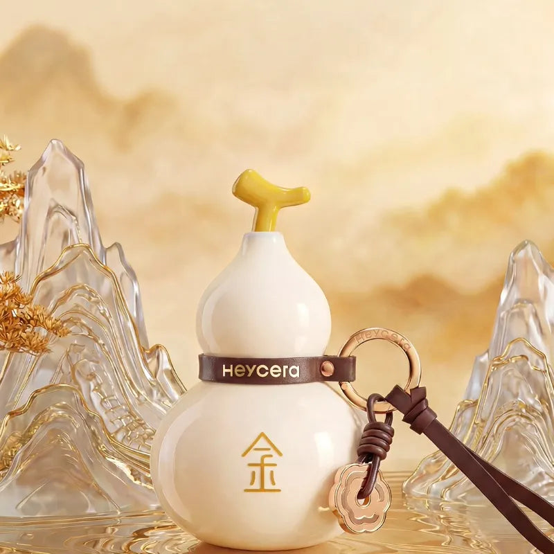 White Metal element porcelain Hulu bag charm displayed with golden mountain-inspired decor in an elegant Chinoiserie setting.