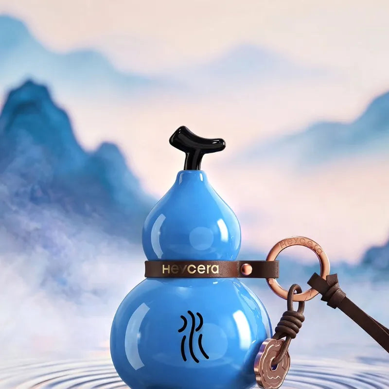 Blue Water element porcelain Hulu bag charm displayed against a serene blue mountain and water-inspired background.