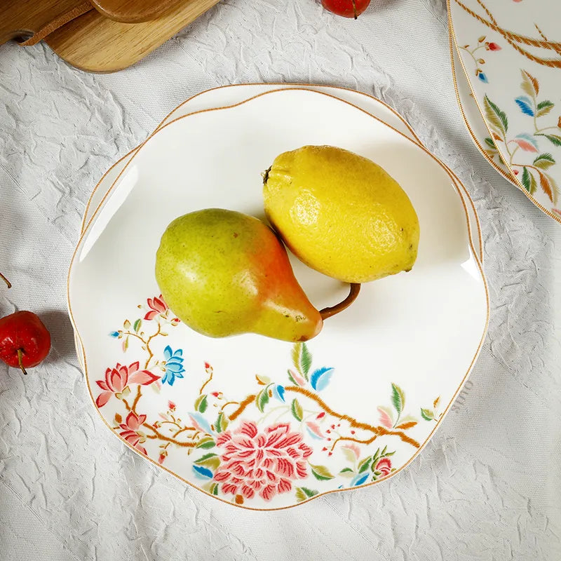 Overhead view of bone china plate with fresh pear on floral design.