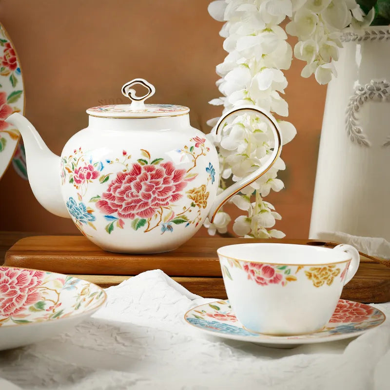Porcelain teapot, cup and saucer on crisp white linen.