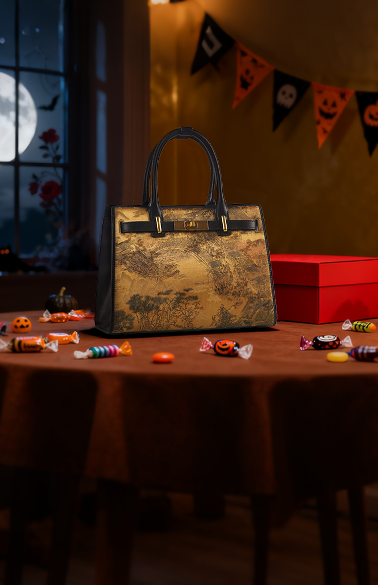Halloween homepage banner featuring a golden landscape handbag, pumpkins, candles, candy, and a cozy spooky vibe (full moon, bunting).