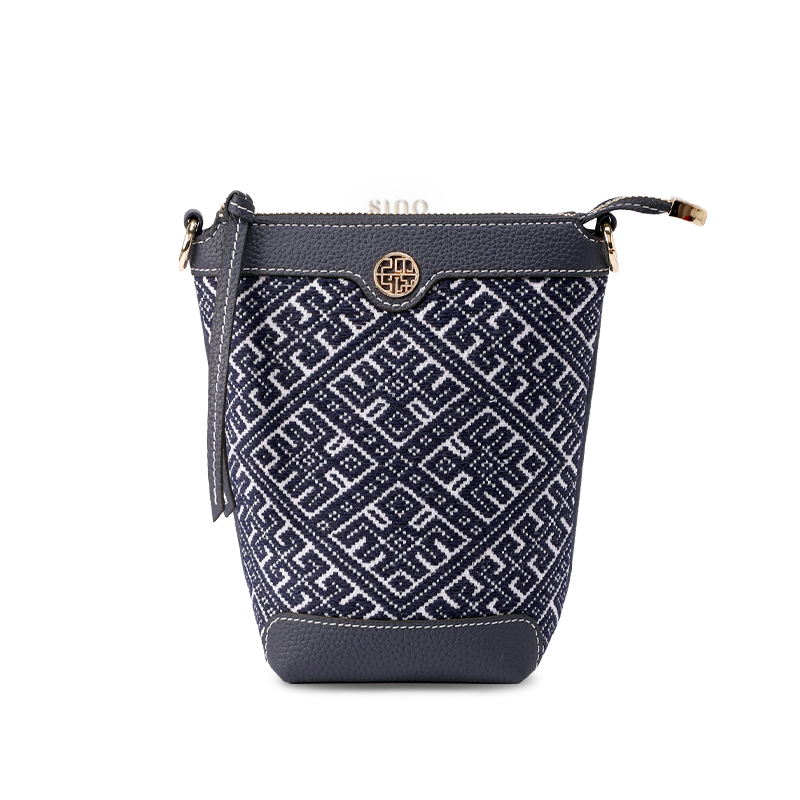 Front view of Zhuang Brocade Flying Swallow Motif Embroidered Leather Bucket Crossbody Bag showcasing traditional embroidery on tapered leather body with adjustable strap.
