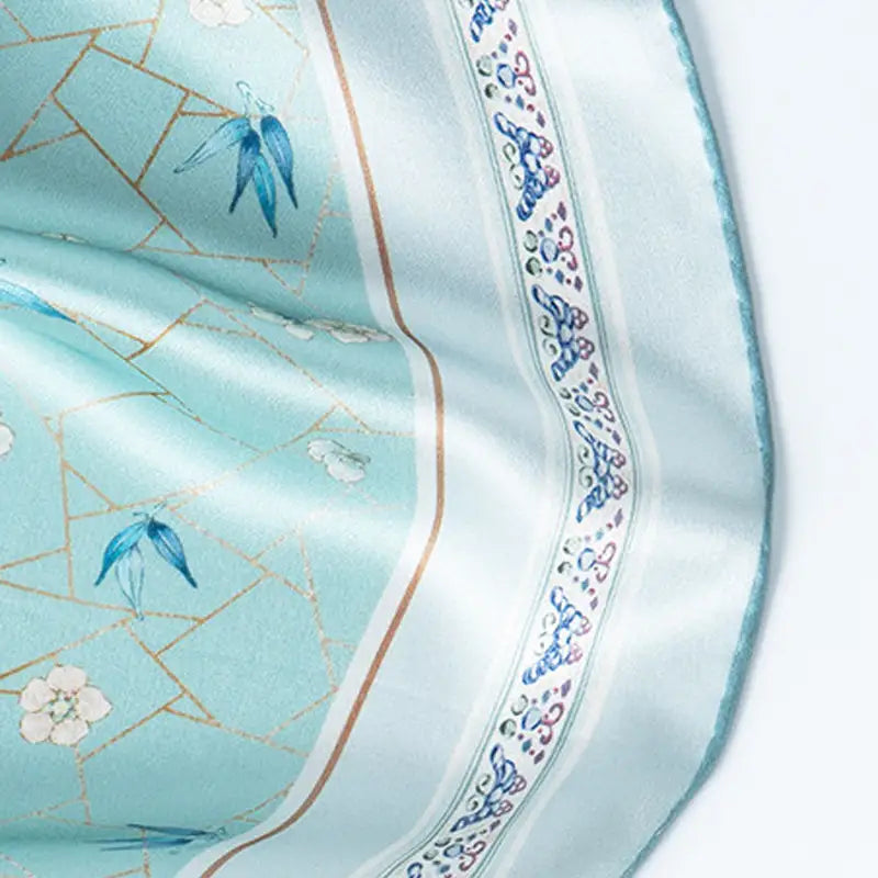 Close-up of the hand-rolled edge and decorative border on the Ice-Crack Plum & Bamboo Mulberry Silk Square Scarf.