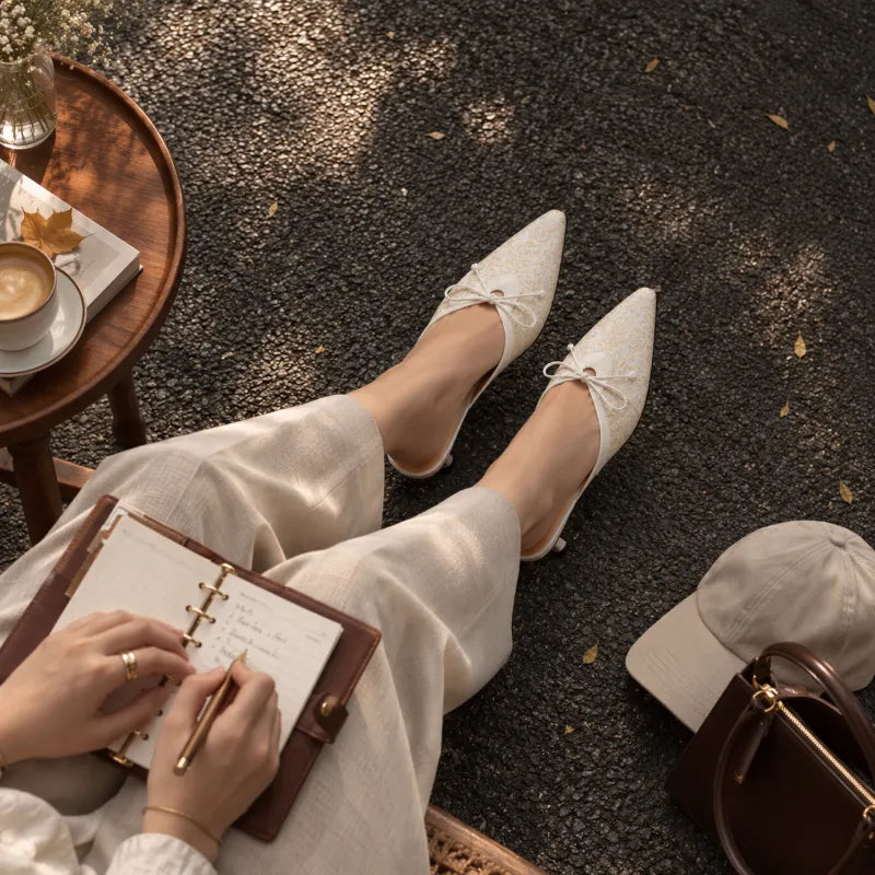 Ivory Song Brocade mule heels styled with a refined outfit, showcasing elegant Chinoiserie fashion for women.