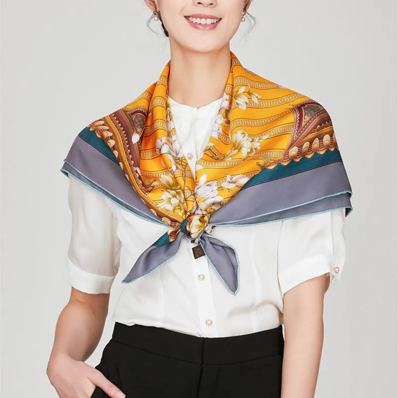 Luxury square scarf with Chinese magnolia design knotted at chest on model.