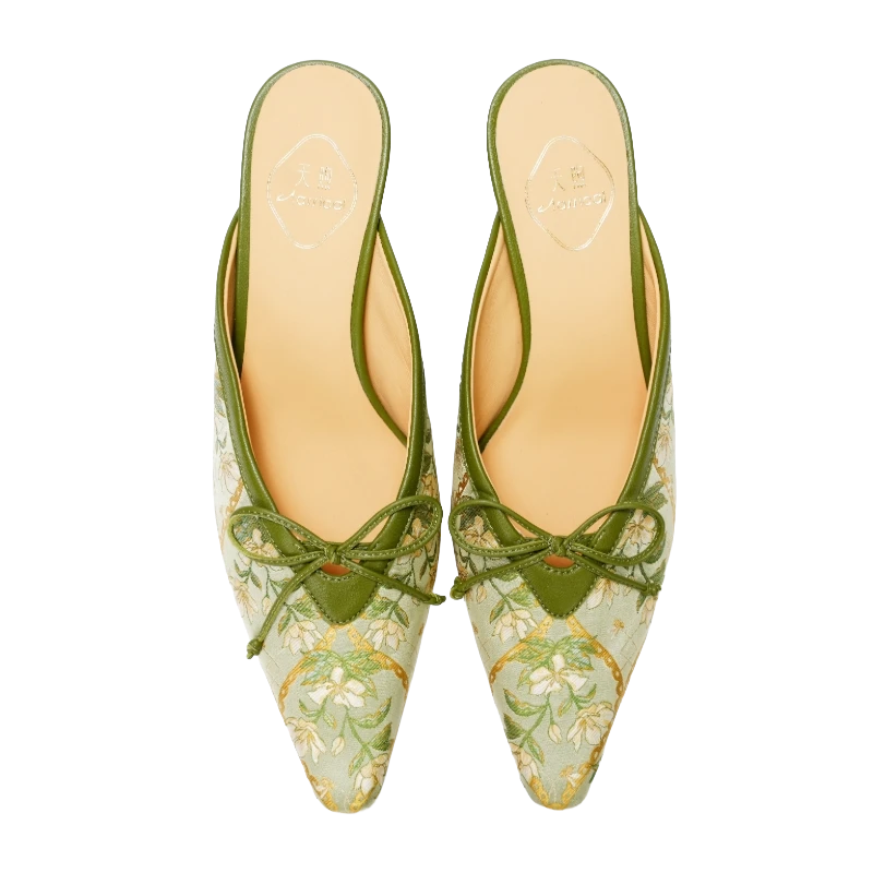 Transparent top view of Luxury Dayun Brocade Verdant Floral kitten heel mules for women featuring green brocade fabric, floral motifs, pointed toes, bow details, and elegant Chinese craftsmanship.