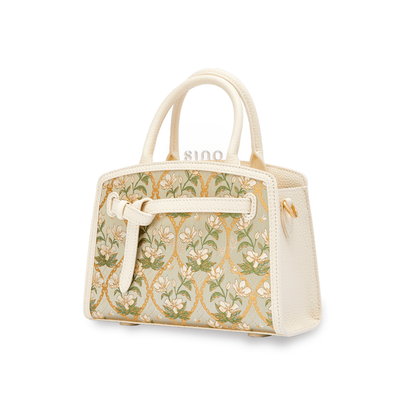 Angled view of the Luxury Dayun Brocade Verdant Floral Large Leather Top Handle Bag showing its structured silhouette and spacious design.