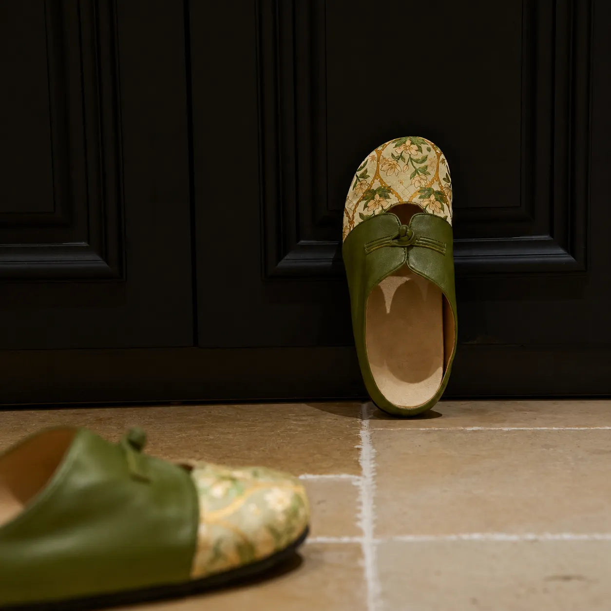 Luxury Dayun Brocade verdant floral mules for women styled against a dark interior backdrop.