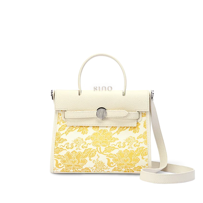 Luxury gold woven Nanjing Brocade top handle bag with cream leather trim front view.