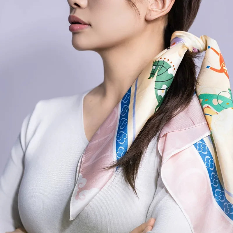 Luxury Nanjing Brocade Nine Horses Print mulberry silk square scarf styled as a hair scarf, showing the pink border and colorful horse design.