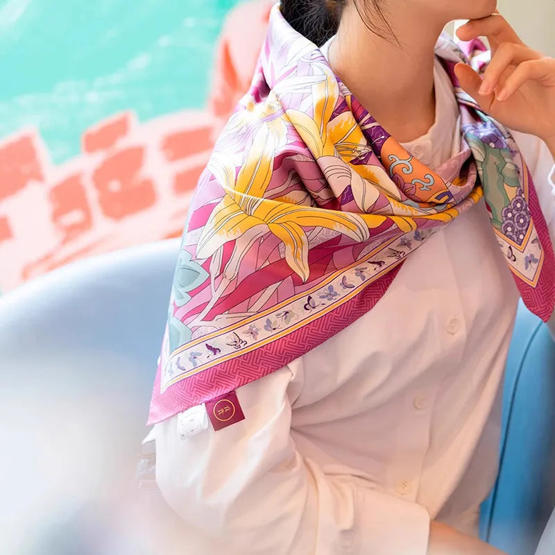 Model wearing a Luxury Nanjing Brocade Spring Floral Vase mulberry silk square scarf draped over the shoulders with colorful floral details.