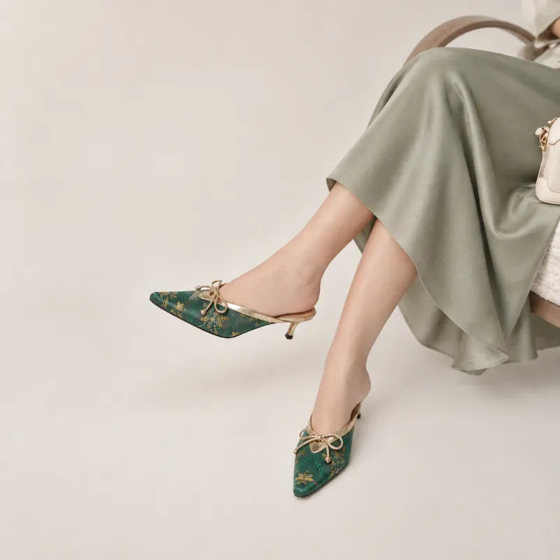 Luxury Shu Brocade emerald gilded butterfly kitten heel mules for women styled with an elegant outfit.