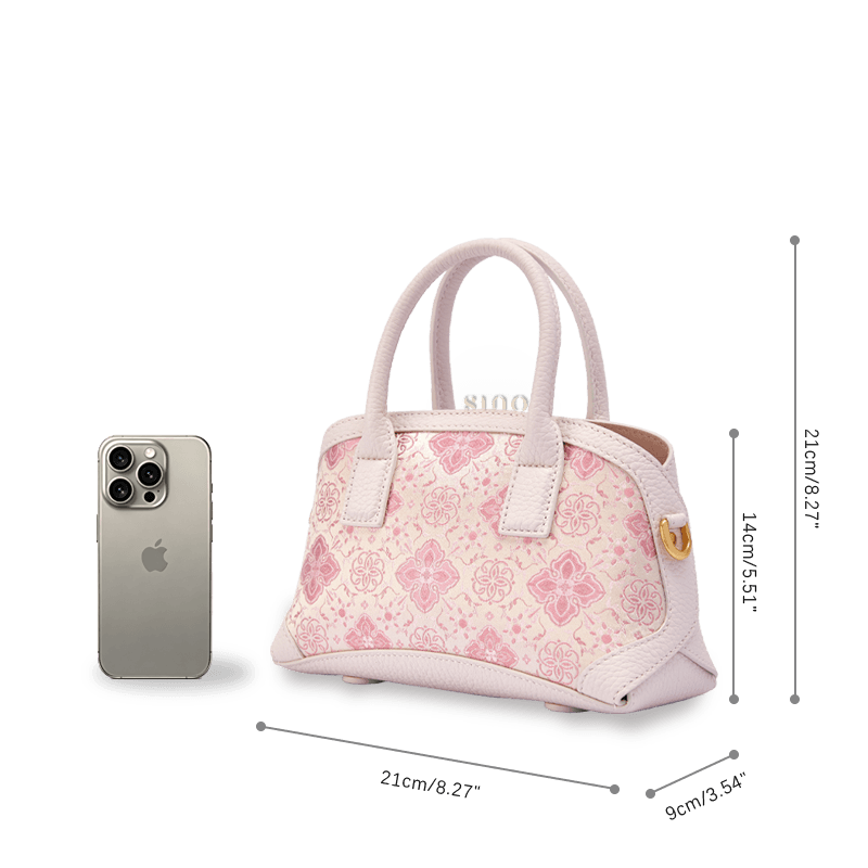 Size reference image of the Luxury Shu Brocade Pink Persimmon Calyx Leather Top Handle Bag beside a smartphone.