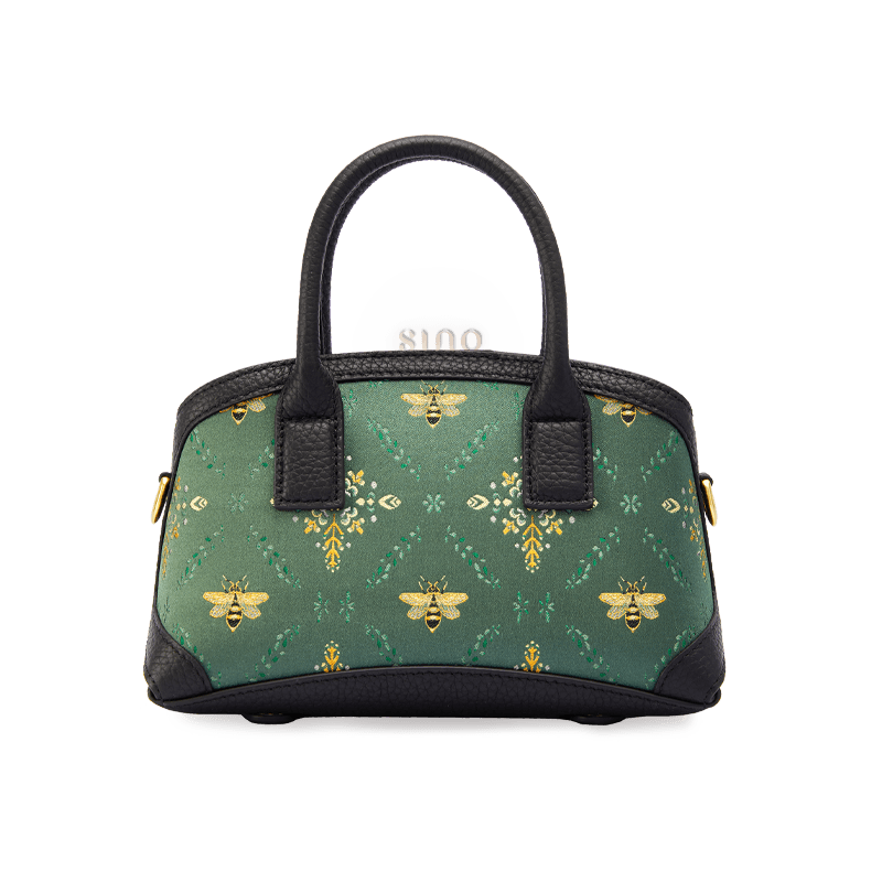 Front view of the Luxury Shu Brocade Verdant Layers Leather Top Handle Bag with green brocade panel, bee motifs, and black leather trim.