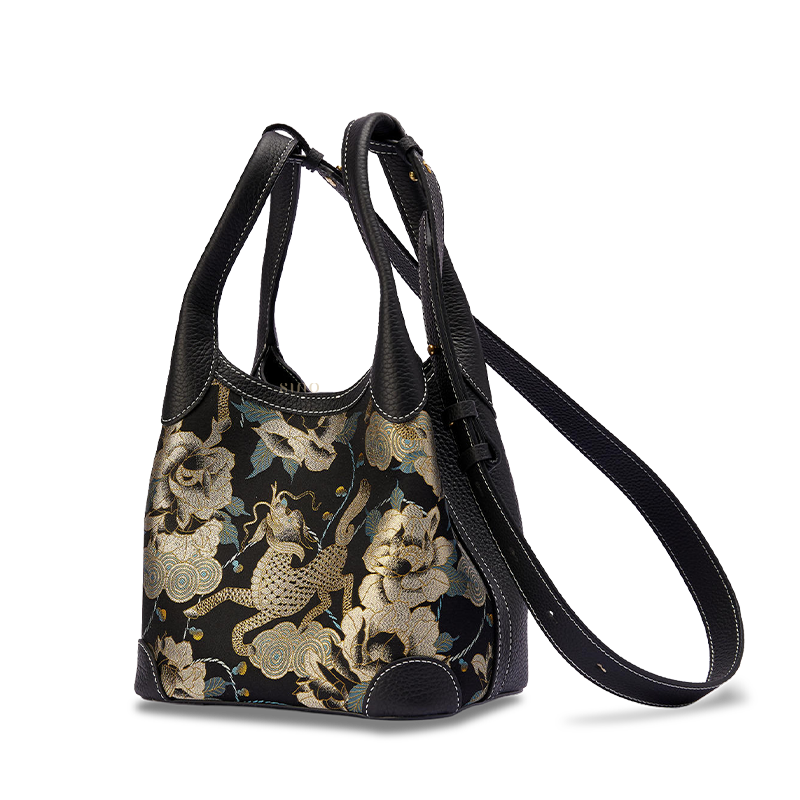 Angled view of luxury basket tote bag with long adjustable strap, highlighting Qilin peony Song Brocade weaving detail.