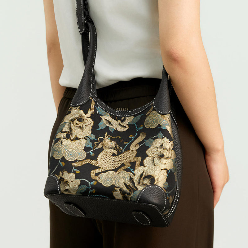 Back view of model wearing luxury Song Brocade leather basket tote bag, showing compact structure and floral Qilin pattern alignment.