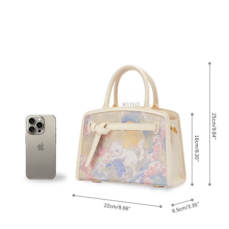 Size reference of the Luxury Song Brocade Brave Voyage Leather Top Handle Bag beside a smartphone, showing its compact structured proportions.