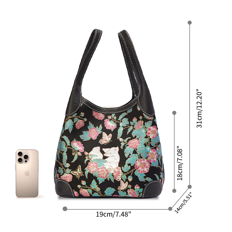 Size reference image of the Luxury Song Brocade Butterfly and Auspicious Fox Basket Tote Bag, shown with a phone for scale and everyday carrying capacity.