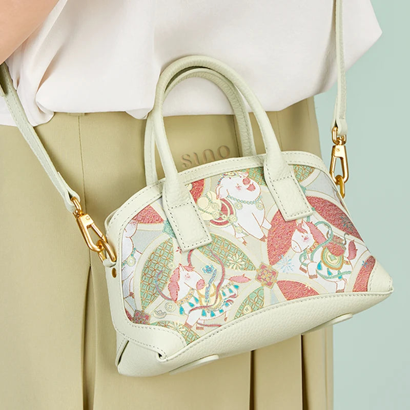 Angled view of the Luxury Song Brocade Enduring Prosperity Leather Top Handle Bag showing its structured silhouette and brocade design.