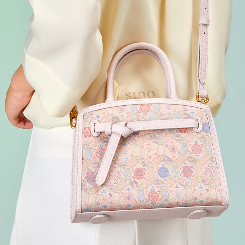 Back lifestyle view of the Luxury Song Brocade Ruyi Longevity Motif Leather Top Handle Bag showing the song brocade pattern and top handle design.