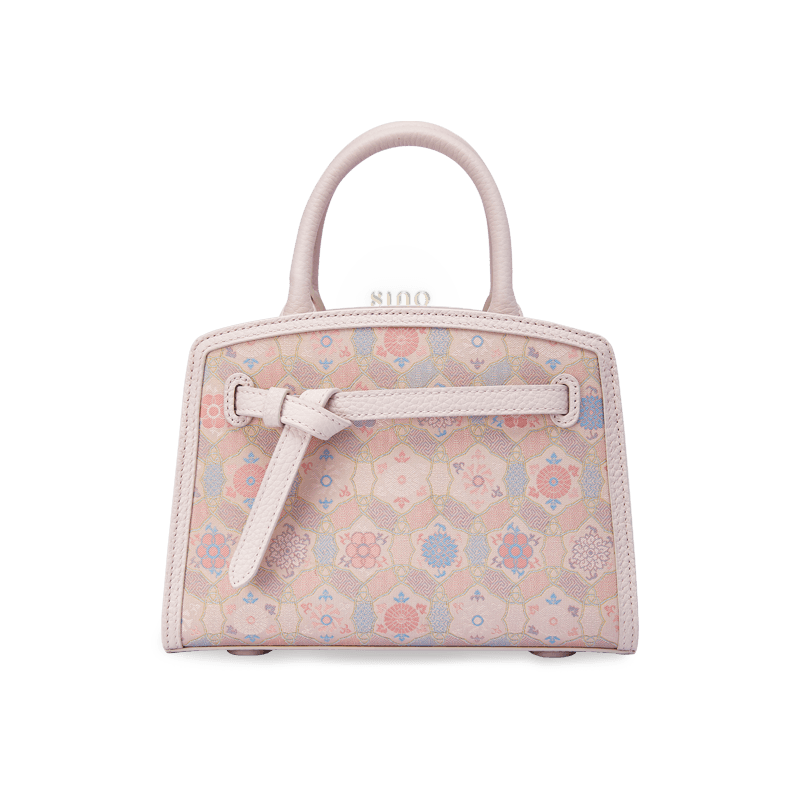 Front view of the Luxury Song Brocade Ruyi Longevity Motif Leather Top Handle Bag featuring a soft pink song brocade pattern and elegant leather trim.