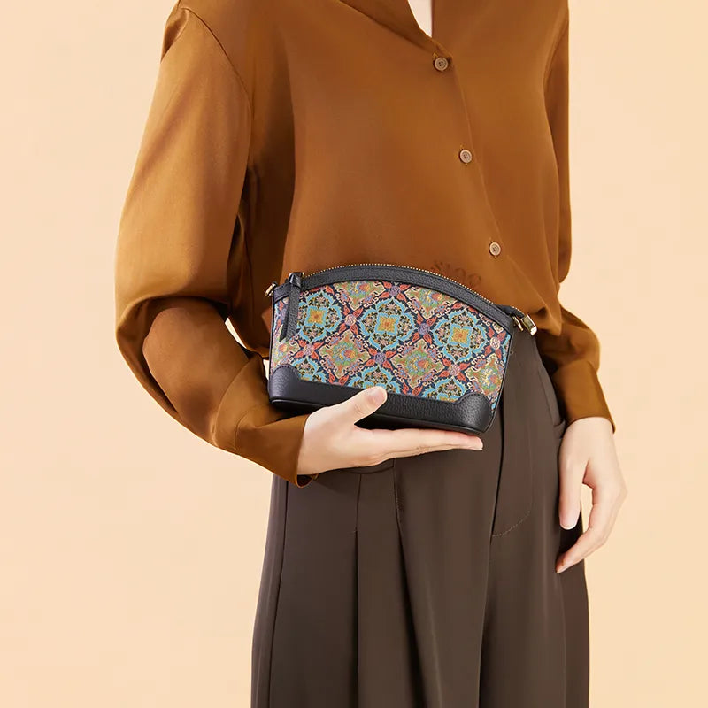 Model holding the Luxury Song Brocade Scrolling Foliage & Lotus Motif Clutch Bag by hand in an elevated display pose.