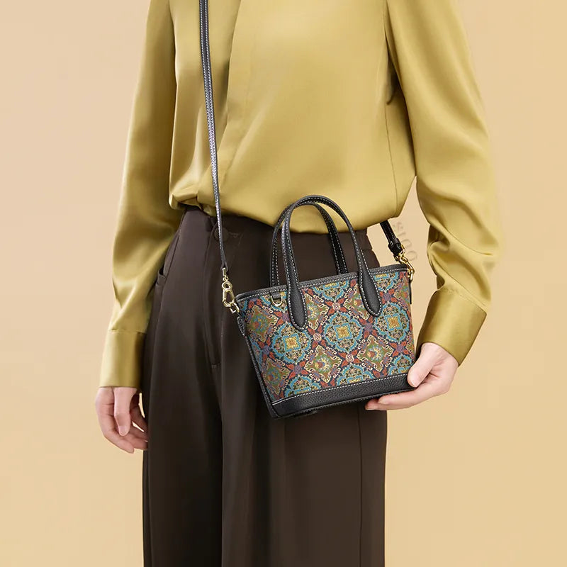 Model wearing the Luxury Song Brocade Scrolling Foliage & Lotus Motif Handbag crossbody, front view, with one hand supporting the bottom.