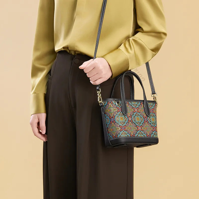 Model wearing the Luxury Song Brocade Scrolling Foliage & Lotus Motif Handbag as a shoulder bag, side view, holding the strap with one hand.