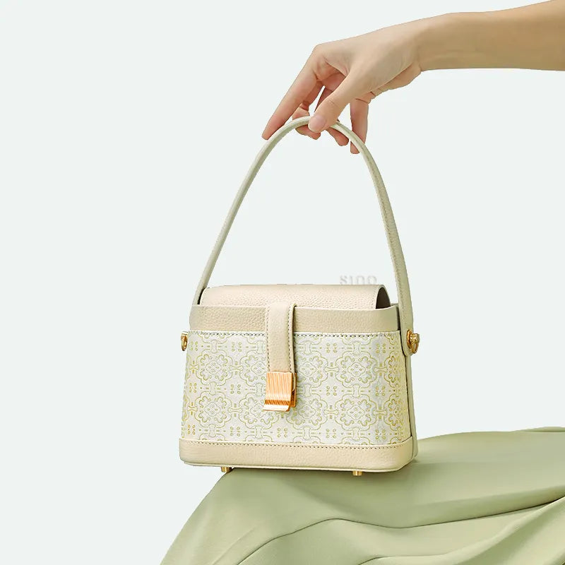 Model sitting with Luxury Song Brocade White & Gold DingSheng Motif Crossbody Bag on knee.