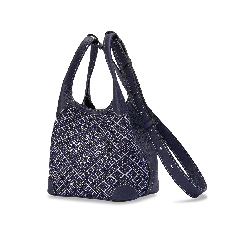 Side view of Chinoiserie luxury Zhuang brocade basket tote bag made with leather and woven fabric showing structured silhouette and premium finishing.
