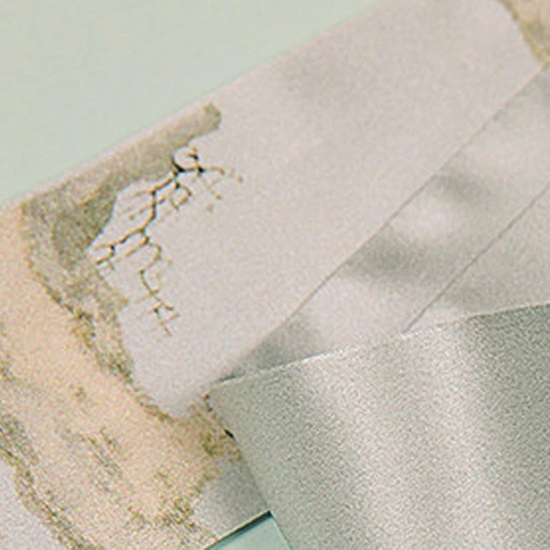 Close-up of the smooth mulberry silk fabric and delicate ink-wash print of the Misty Landscape Twilly.