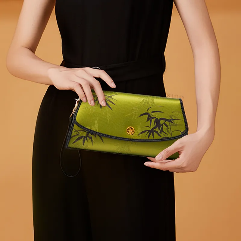 Model in Black Qipao Holding Chinoiserie Vintage Bamboo Silk Clutch.