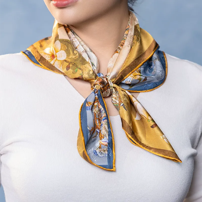 Luxury Nanjing Brocade Bloom mulberry silk square scarf tied in a front neck knot with gold and blue double-sided print.