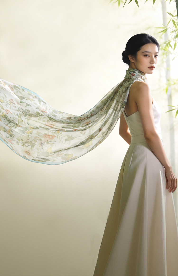 Model wearing Sinocultural‘s new floral mulberry silk scarf in soft bamboo setting.