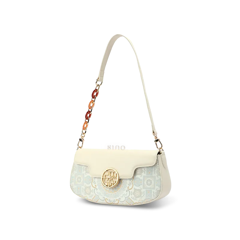 Profile of luxury white brocade shoulder bag showing depth.