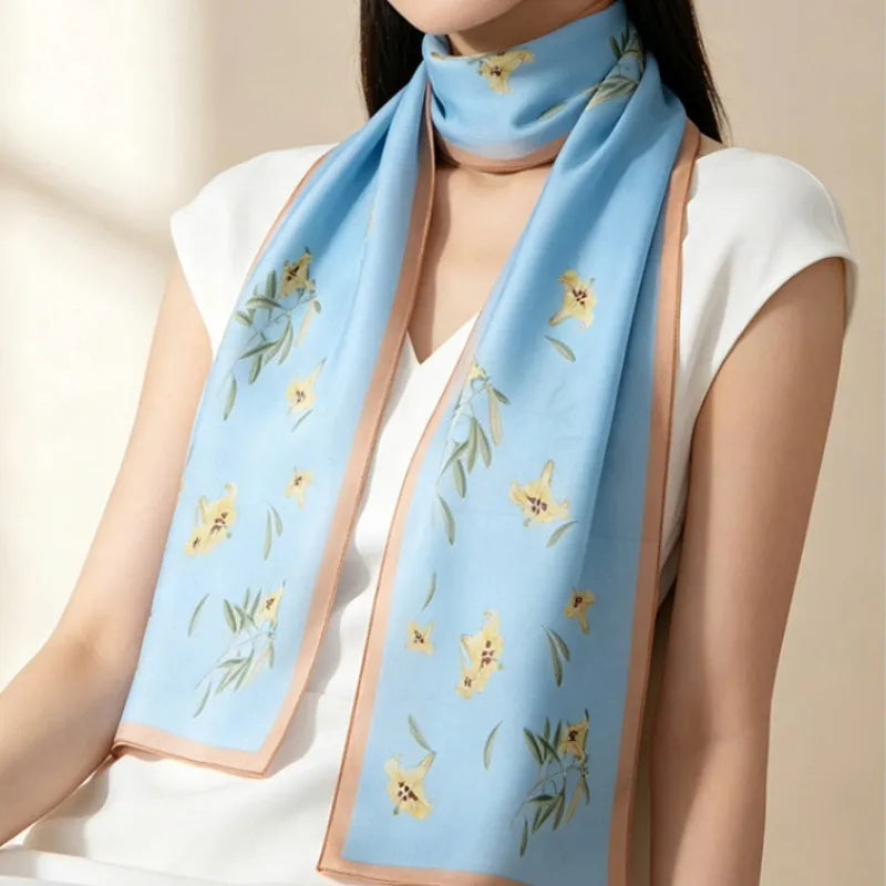 Woman wearing the Blue Lily Poetic Blossom Mulberry Silk Long Scarf as an elegant neck scarf.