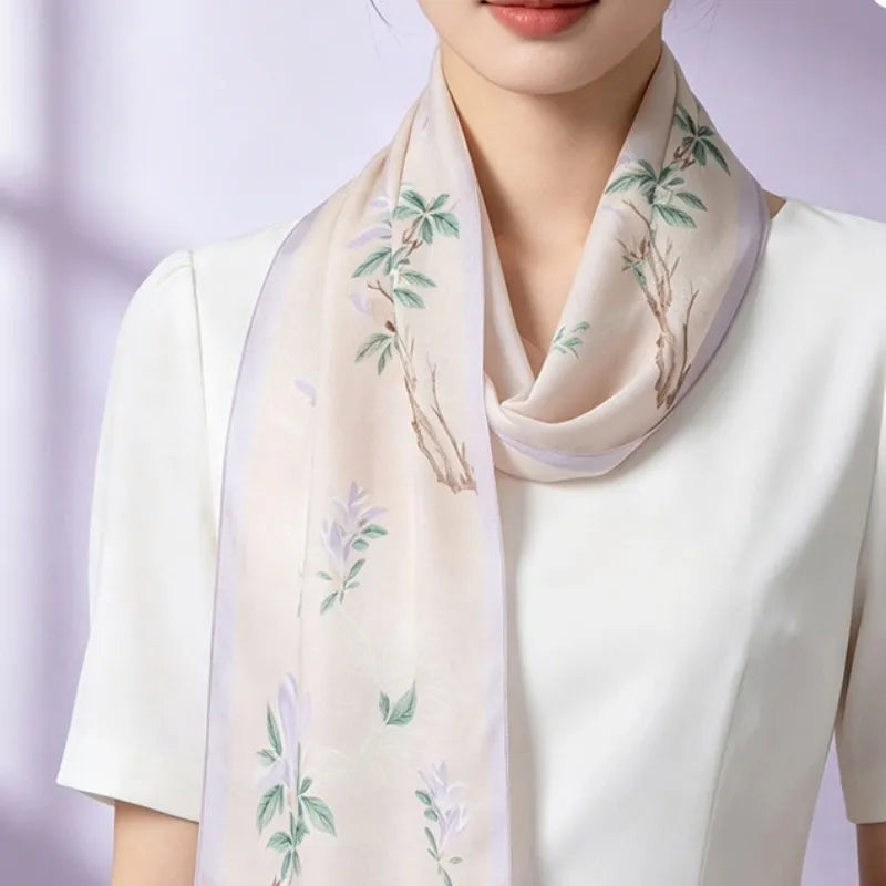 Woman wearing the White Magnolia Poetic Blossom Mulberry Silk Long Scarf draped elegantly around the neck.