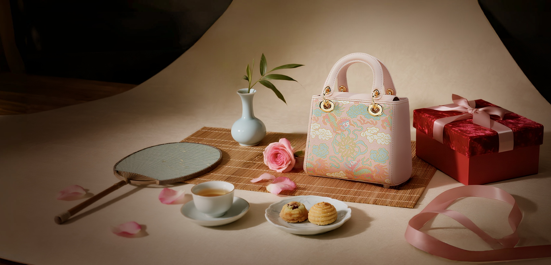 Qixi Festival banner: Pink traditional handbag with dragon/cloud patterns, red gift box, teacup, and romantic Chinese decor.