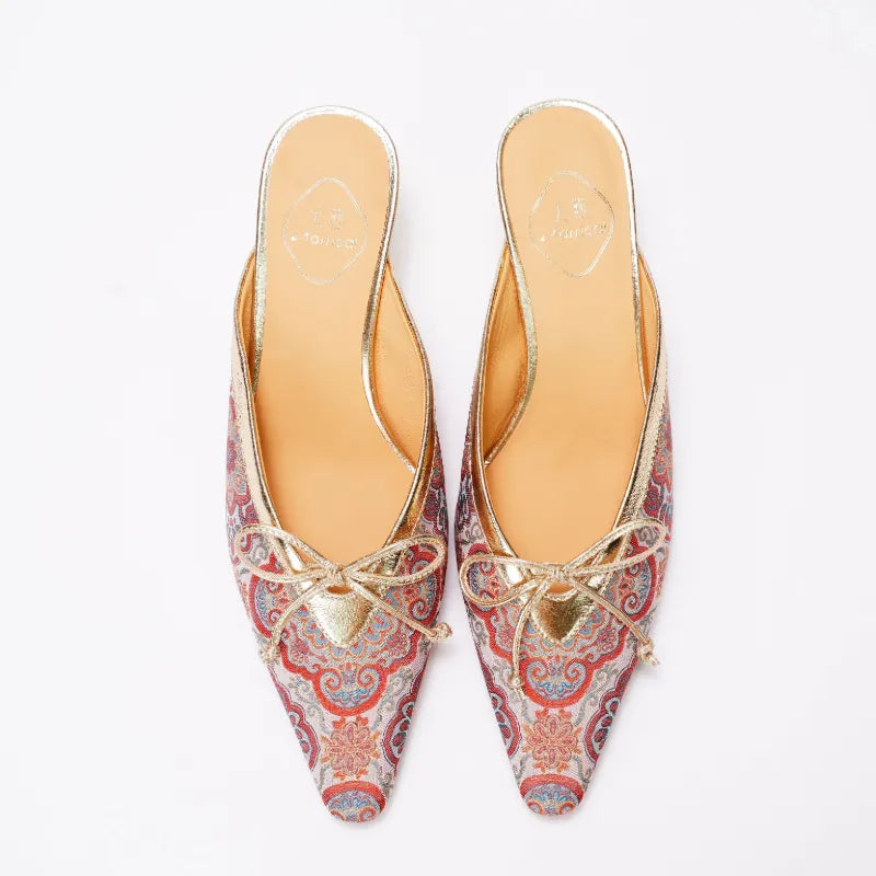 Front view of red Song Brocade kitten heel mules with symmetrical floral embroidery pattern.
